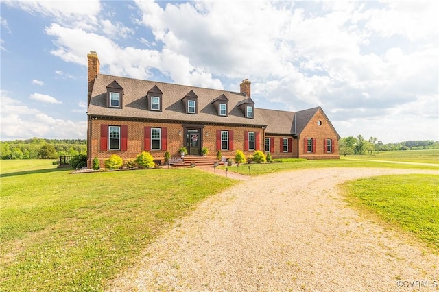 cape cod home featuring brick siding, a front lawn, and a chimney