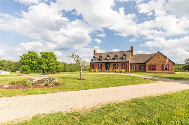 cape cod-style house with a chimney and a front lawn