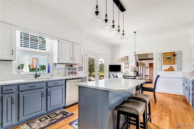 kitchen with a sink, gray cabinets, dishwasher, and ornamental molding