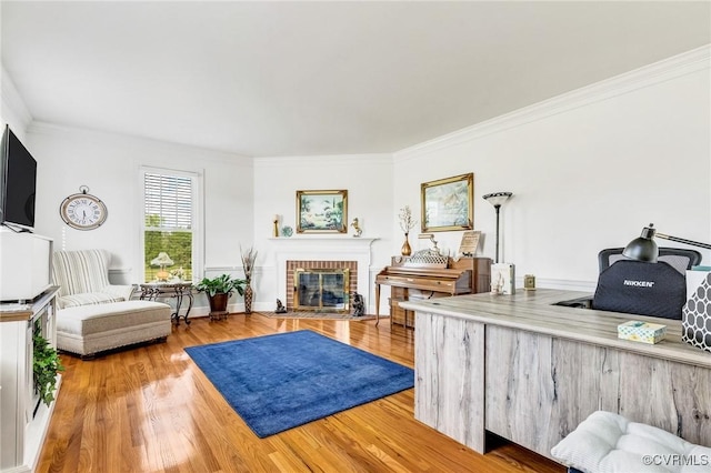 living room featuring a brick fireplace, ornamental molding, and wood finished floors