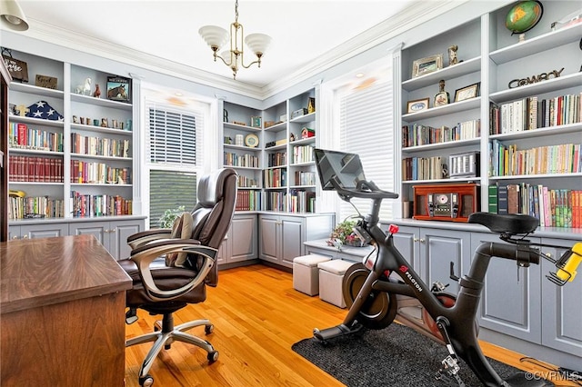office featuring crown molding, light wood-style floors, and a chandelier