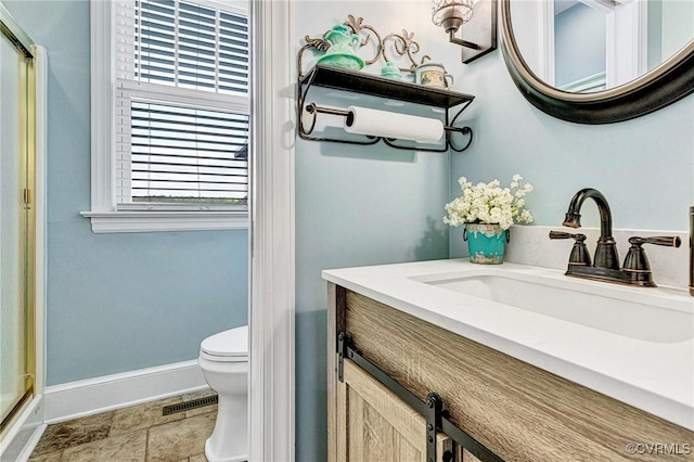 bathroom with visible vents, vanity, toilet, baseboards, and an enclosed shower