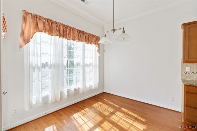 9533 Ashleyville Turn, Midlothian, VA 23112 - unfurnished dining area with ornamental molding, healthy amount of natural light, light wood-style floors, and baseboards