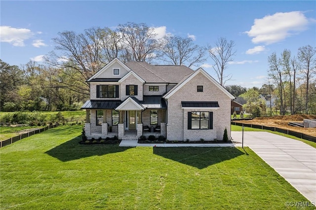 2710 Maidens Rd, Powhatan, VA 23139 - view of front of property with covered porch, a standing seam roof, a front yard, brick siding, and fence