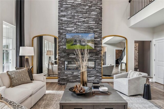 2710 Maidens Rd, Powhatan, VA 23139 - living room featuring a high ceiling, a stone fireplace, and wood finished floors