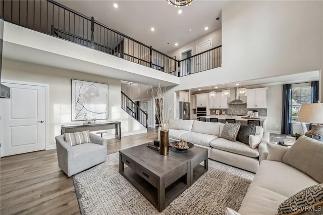 2710 Maidens Rd, Powhatan, VA 23139 - living area with baseboards, light wood-type flooring, stairway, and a towering ceiling