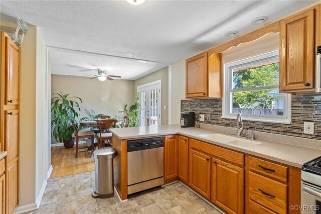 31 Warren Dr, Newport News, VA 23608 - kitchen featuring stainless steel appliances, a sink, decorative backsplash, a peninsula, and plenty of natural light