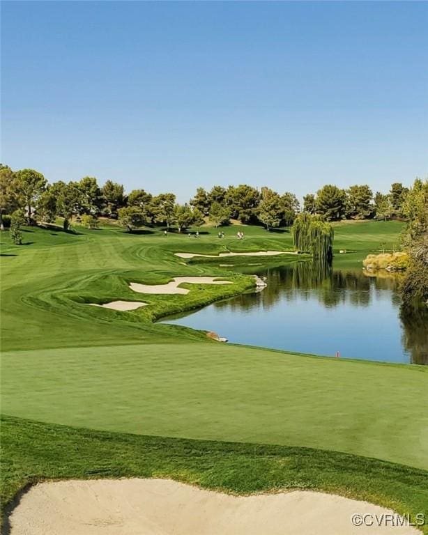 view of home's community with a water view and view of golf course