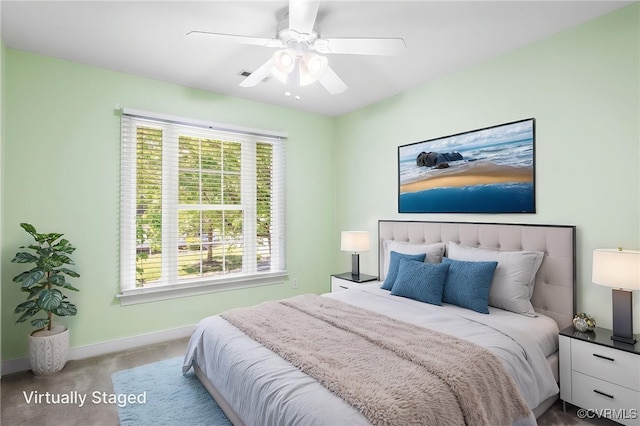 bedroom featuring baseboards, multiple windows, carpet flooring, and ceiling fan