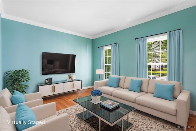 living room featuring baseboards, ornamental molding, and wood finished floors