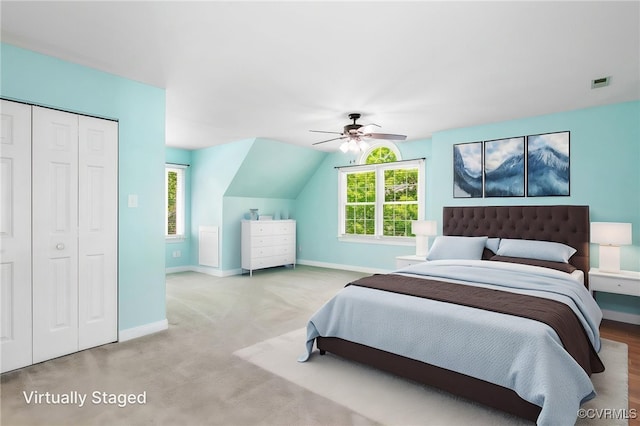 bedroom with baseboards, visible vents, multiple windows, and a closet