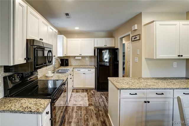 kitchen featuring black appliances, dark wood-style flooring, a sink, white cabinetry, and recessed lighting