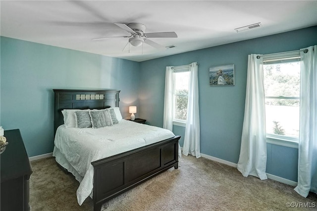 carpeted bedroom with baseboards and ceiling fan