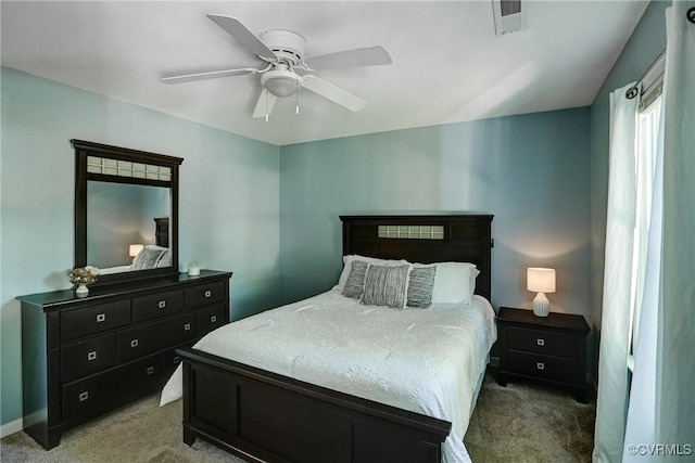 bedroom with light colored carpet, a ceiling fan, and baseboards