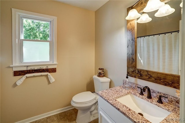 bathroom with baseboards, toilet, vanity, and a shower with shower curtain