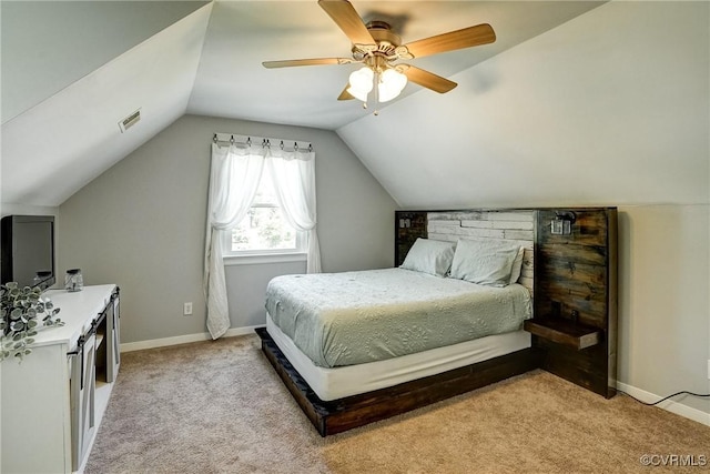 bedroom with lofted ceiling, light colored carpet, a ceiling fan, and baseboards