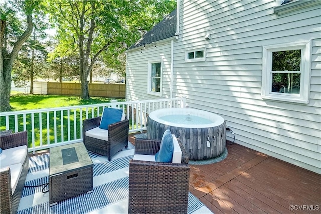 wooden terrace with outdoor lounge area and a hot tub