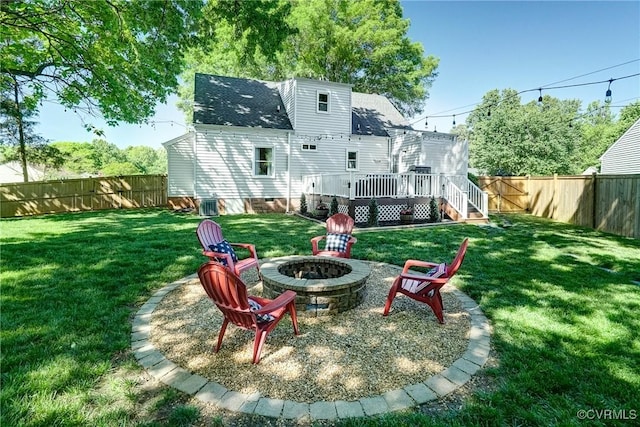 rear view of house with an outdoor fire pit, a wooden deck, central AC, and roof with shingles