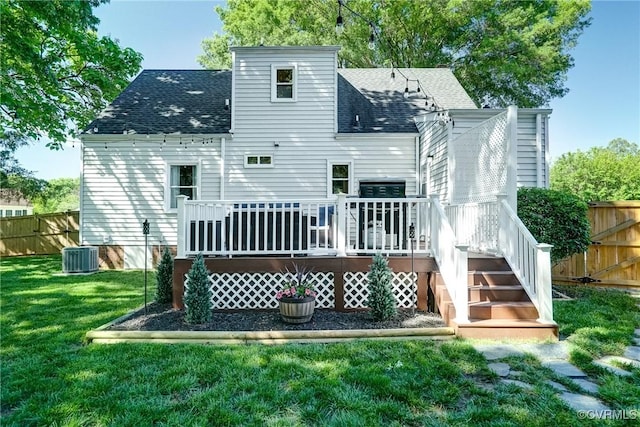rear view of property with roof with shingles, a wooden deck, and central AC