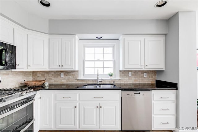 kitchen featuring black microwave, dishwasher, range with two ovens, a sink, and backsplash