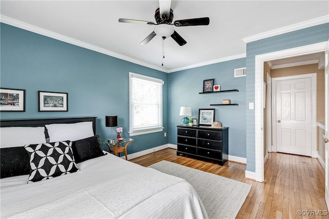 bedroom with a ceiling fan, visible vents, crown molding, baseboards, and wood-type flooring