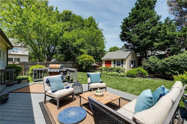 wooden terrace with area for grilling, a fenced backyard, an outdoor living space, an outdoor structure, and a yard