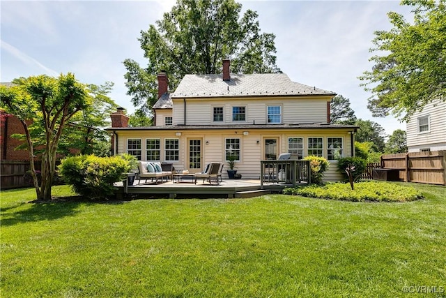 back of house featuring fence, a chimney, and an outdoor living space