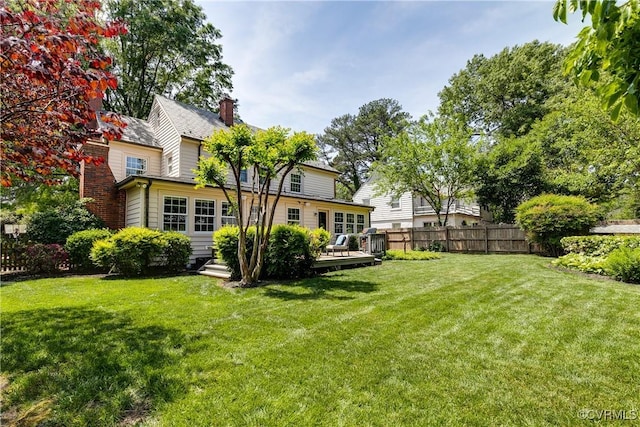view of yard featuring fence and a wooden deck