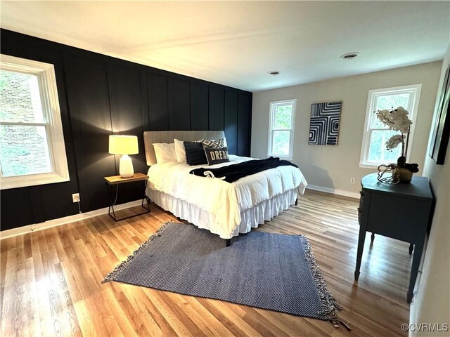 bedroom featuring wood finished floors and baseboards