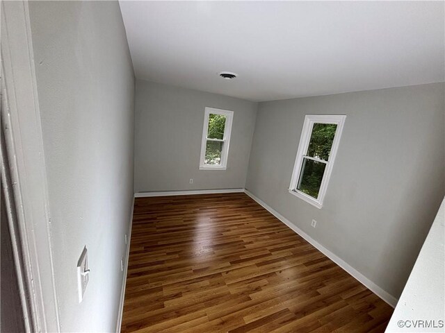 unfurnished room featuring wood finished floors and baseboards