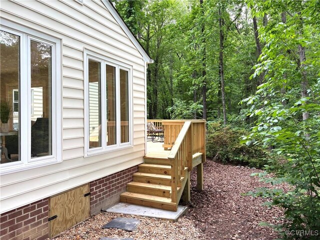 view of side of property with crawl space and a wooden deck