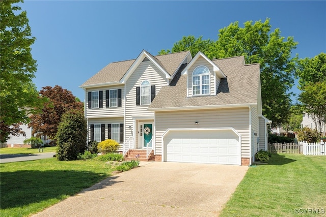 view of front of property with driveway, roof with shingles, a front yard, fence, and an attached garage