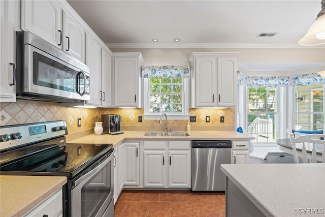 kitchen featuring light countertops, white cabinetry, appliances with stainless steel finishes, and a sink