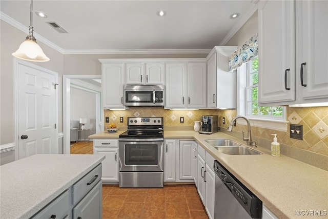 kitchen featuring visible vents, appliances with stainless steel finishes, hanging light fixtures, a sink, and white cabinetry