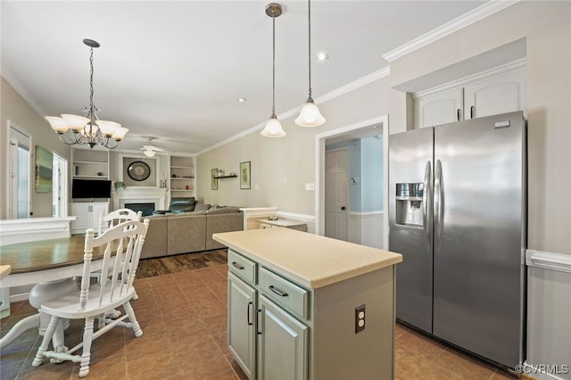kitchen featuring crown molding, a center island, built in features, and stainless steel refrigerator with ice dispenser