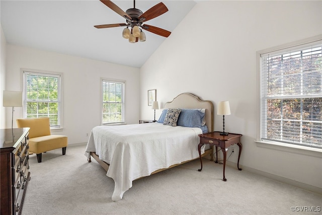 bedroom featuring a ceiling fan, high vaulted ceiling, light carpet, and baseboards