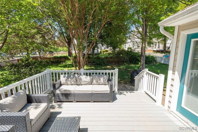 wooden terrace with a fenced backyard and outdoor lounge area