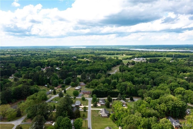 drone / aerial view with a wooded view
