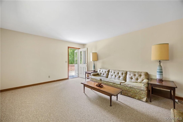 living area with baseboards and carpet