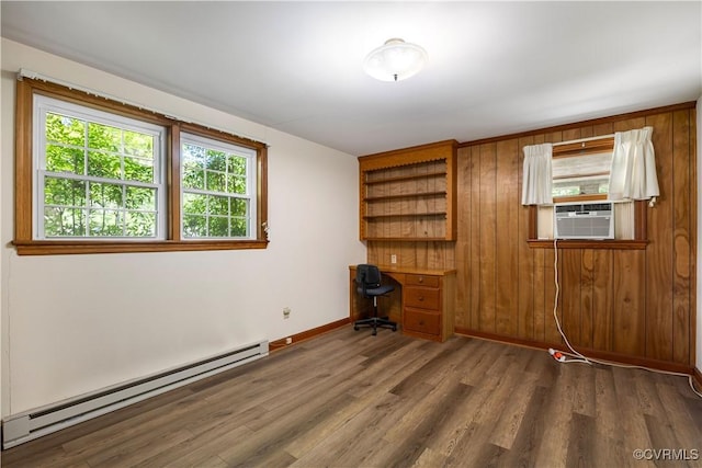 empty room featuring baseboards, cooling unit, a baseboard heating unit, and dark wood finished floors