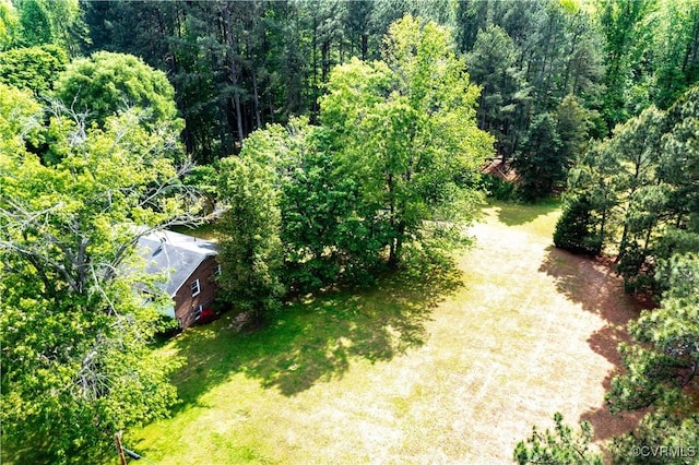 birds eye view of property featuring a view of trees