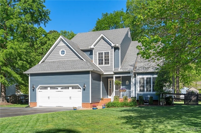 craftsman inspired home featuring a garage, aphalt driveway, a front yard, a shingled roof, and a porch