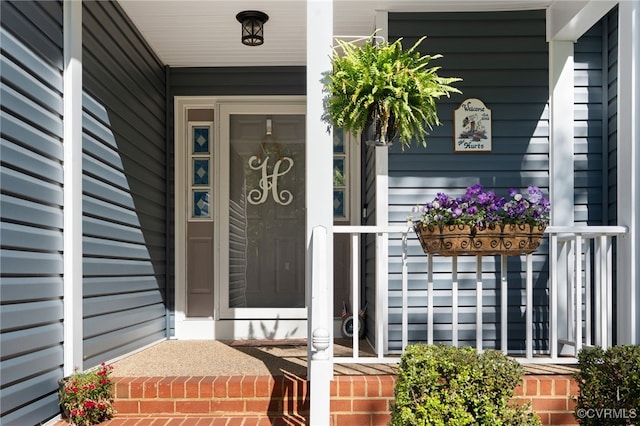view of exterior entry featuring a porch