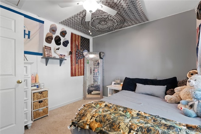 bedroom featuring baseboards, a ceiling fan, and carpet flooring