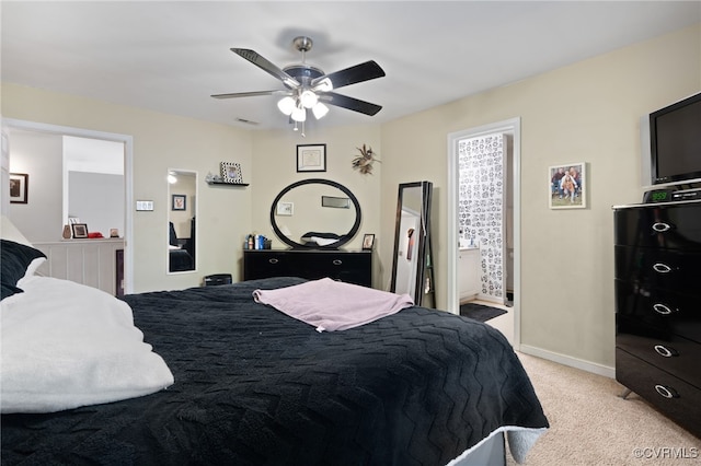 bedroom featuring ceiling fan, light carpet, baseboards, ensuite bathroom, and visible vents