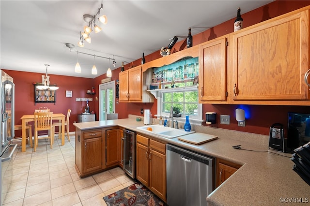 kitchen with dishwasher, a sink, a peninsula, beverage cooler, and an inviting chandelier