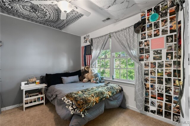 bedroom with carpet floors, baseboards, and visible vents