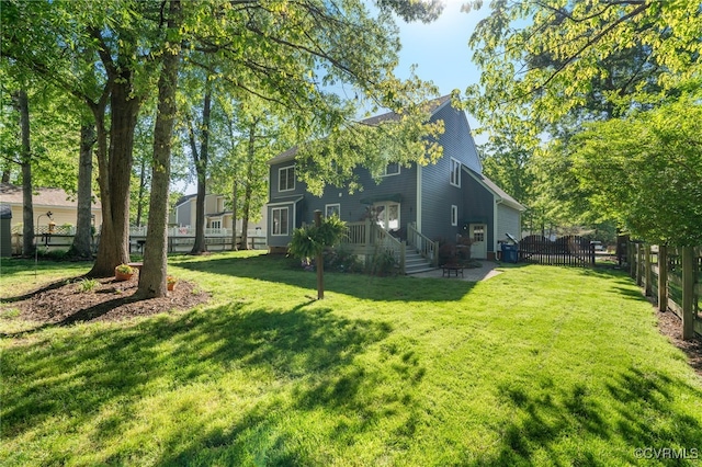 exterior space featuring a lawn and fence