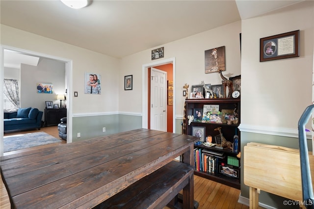 dining space with hardwood / wood-style flooring