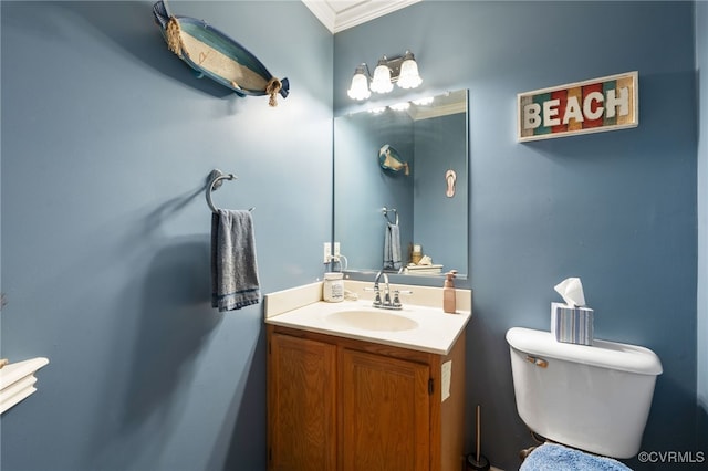 half bathroom featuring crown molding, toilet, and vanity